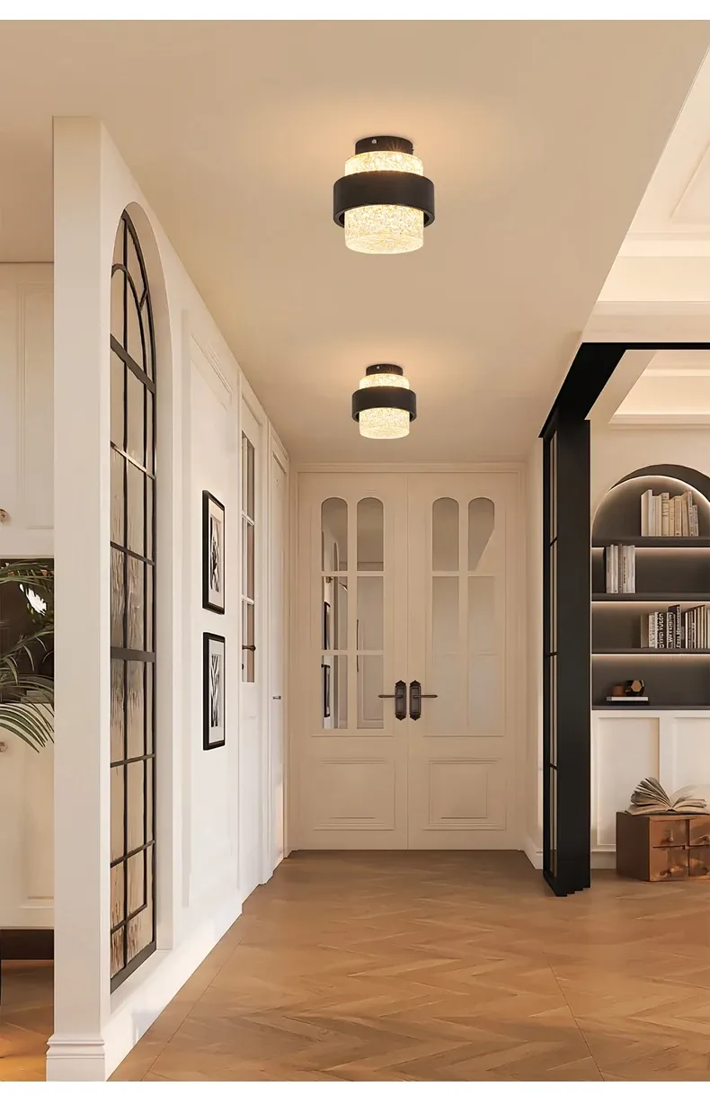 שני גופי תאורה בתקרה במסדרון עם דלתות לבנות